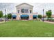 Picturesque view of The Improper Pig with tables and chairs outside and a pristine lawn at 8065 Cornhill Ave, Charlotte, NC 28277