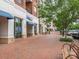 Street view of Flour Power bakery and restaurants with brick paver sidewalk and outdoor seating at 8065 Cornhill Ave, Charlotte, NC 28277