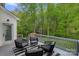 Relax on the back deck of this home, featuring a stylish outdoor rug, comfortable seating and beautiful wooded view at 8600 Glade Ct, Huntersville, NC 28078