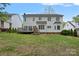 Expansive backyard showcasing a well-maintained lawn, patio, and the rear of the house at 8600 Glade Ct, Huntersville, NC 28078