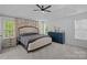 Brightly lit bedroom boasting a tray ceiling, dual windows, and an elegant design at 8600 Glade Ct, Huntersville, NC 28078