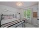 Bright bedroom with a unique patterned ceiling, large window, and cozy decor at 8600 Glade Ct, Huntersville, NC 28078