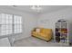Bright bedroom with a yellow sofa, large window, and playful decor at 8600 Glade Ct, Huntersville, NC 28078
