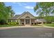 Charming community clubhouse featuring manicured landscaping, columns, and covered entry at 8600 Glade Ct, Huntersville, NC 28078