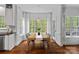 Sunlit dining area featuring hardwood floors and a large window with a view of the backyard at 8600 Glade Ct, Huntersville, NC 28078