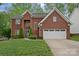 Beautiful two-story brick home with well-manicured lawn and attached two-car garage at 8600 Glade Ct, Huntersville, NC 28078