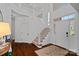 Bright, spacious foyer with high ceilings, hardwood floors, and a staircase with white railings at 8600 Glade Ct, Huntersville, NC 28078