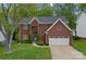 Inviting brick home with manicured lawn, attached garage, and well-maintained landscaping for enhanced curb appeal at 8600 Glade Ct, Huntersville, NC 28078