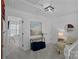 Upstairs hallway with neutral carpet, seating area, and access to additional rooms at 8600 Glade Ct, Huntersville, NC 28078