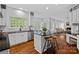 Bright kitchen with stainless appliances, island with bar seating, and hardwood flooring at 8600 Glade Ct, Huntersville, NC 28078
