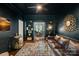 Elegant living room with dark walls, built-in shelves, and a comfortable leather sofa at 8600 Glade Ct, Huntersville, NC 28078