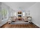 Spacious living room featuring a fireplace, hardwood floors, and natural light at 8600 Glade Ct, Huntersville, NC 28078