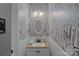 Charming powder room with decorative wallpaper, wainscoting, and an ornate mirror at 8600 Glade Ct, Huntersville, NC 28078