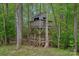 Unique two-story treehouse nestled amongst trees, offering a fun outdoor retreat at 8600 Glade Ct, Huntersville, NC 28078
