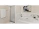 Bright bathroom showcasing a soaking tub with white tile surround, art, and separate shower at 921 Northeast Dr # 39, Davidson, NC 28036