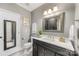 Bathroom vanity with marble countertop, decorative mirror, toilet, and decorative artwork at 921 Northeast Dr # 39, Davidson, NC 28036