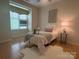 Cozy bedroom featuring a twin bed, soft lighting, and a large window at 921 Northeast Dr # 39, Davidson, NC 28036