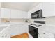 Efficient kitchen featuring white countertops and black appliances, optimizing space and functionality at 921 Northeast Dr # 39, Davidson, NC 28036