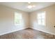A cozy bedroom with a ceiling fan, two windows, wood-look floors, and neutral paint at 1011 Rickert St, Statesville, NC 28677