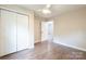 Bedroom boasts wood-look floors, a ceiling fan, and a spacious closet at 1011 Rickert St, Statesville, NC 28677