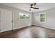Inviting bedroom with wood-look flooring, a ceiling fan, and windows overlooking a green landscape at 1011 Rickert St, Statesville, NC 28677