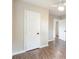 Hallway featuring wood-look floors, neutral paint, and white doors at 1011 Rickert St, Statesville, NC 28677
