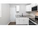 Bright white kitchen with granite countertops, stainless steel appliances, and wood-look vinyl flooring at 1011 Rickert St, Statesville, NC 28677