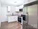 Newly remodeled kitchen with white cabinets, granite counters, stainless appliances, and durable vinyl floor at 1011 Rickert St, Statesville, NC 28677