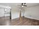 Spacious living area with wood-look flooring, open to kitchen, and well-lit with neutral walls at 1011 Rickert St, Statesville, NC 28677
