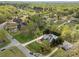 Aerial view of the home in a lush, green neighborhood, showcasing landscaping, pool, and surrounding properties at 110 Devonshire Ln, Salisbury, NC 28146