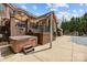 Exterior of brick home featuring hot tub, patio with dining, and a basketball hoop for outdoor fun and relaxation at 110 Devonshire Ln, Salisbury, NC 28146