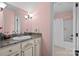 Bathroom featuring a sink with a granite countertop, white cabinets and view into the shower and bath at 110 Devonshire Ln, Salisbury, NC 28146