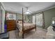 Cozy bedroom featuring a four-poster bed, soft lighting, and bright windows at 110 Devonshire Ln, Salisbury, NC 28146