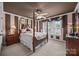 Elegant bedroom featuring a four-poster bed, neutral carpet, and bright window offering ample natural light at 110 Devonshire Ln, Salisbury, NC 28146