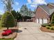 Spacious driveway leads to a three-car garage and a meticulously landscaped backyard with privacy fence at 110 Devonshire Ln, Salisbury, NC 28146
