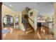 Open foyer with hardwood floors, staircase, and views into the dining and kitchen at 110 Devonshire Ln, Salisbury, NC 28146