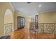 Elegant hallway with hardwood floors, decorative railings, and arched entryway at 110 Devonshire Ln, Salisbury, NC 28146