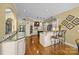 Open concept kitchen with hardwood floors, granite countertops, and stainless steel appliances at 110 Devonshire Ln, Salisbury, NC 28146