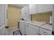 Functional laundry room featuring a washer and dryer, utility sink, and ample cabinet space for storage at 110 Devonshire Ln, Salisbury, NC 28146