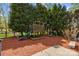 Backyard playground with play structure, slide, and swing set surrounded by lush greenery creates a fun space at 110 Devonshire Ln, Salisbury, NC 28146
