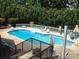 Backyard pool with diving board, sun loungers, umbrellas, and well-maintained landscaping offers a private oasis at 110 Devonshire Ln, Salisbury, NC 28146