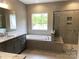 Beautiful bathroom with a soaking tub, tiled shower, and double vanity with marble countertops at 117 Blackbeard Ln, Mooresville, NC 28117