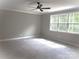 Spacious bedroom with carpet, a ceiling fan, and a large window for natural light at 117 Blackbeard Ln, Mooresville, NC 28117