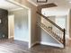 Inviting entryway featuring hardwood floors and staircase with modern white and wood banister at 117 Blackbeard Ln, Mooresville, NC 28117