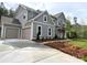 Beautiful two-story home featuring a three-car garage, landscaped yard and inviting front porch at 117 Blackbeard Ln, Mooresville, NC 28117