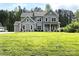 Large, gray two-story home with lush green lawn and meticulously landscaped front yard at 117 Blackbeard Ln, Mooresville, NC 28117