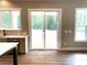Bright kitchen area featuring stainless steel appliances, wood floors and large sliding glass doors at 117 Blackbeard Ln, Mooresville, NC 28117