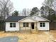 Charming single-story home boasting a classic design, natural wood accents, and a welcoming covered porch at 1212 Belmont Circle Dr, Lancaster, SC 29720