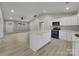 Bright kitchen featuring white cabinets, quartz countertops, modern appliances and an adjacent living space at 1212 Belmont Circle Dr, Lancaster, SC 29720