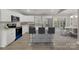 Modern kitchen features white cabinets, quartz countertops, stainless steel appliances, and sleek breakfast bar seating at 1212 Belmont Circle Dr, Lancaster, SC 29720